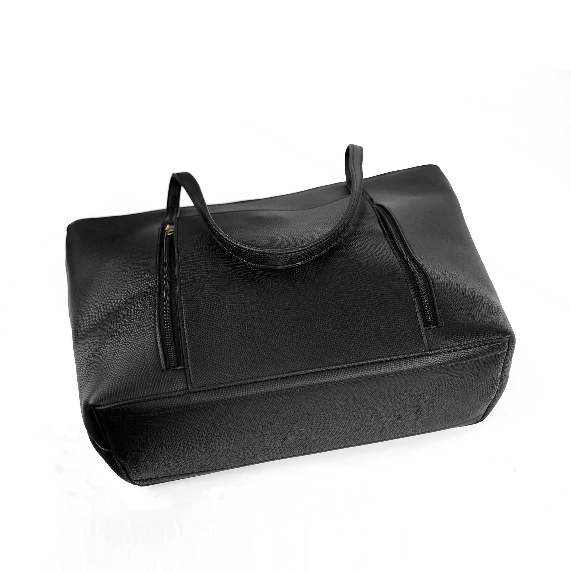 Angled view of the Zara black handbag, showcasing the front pockets and dual straps.