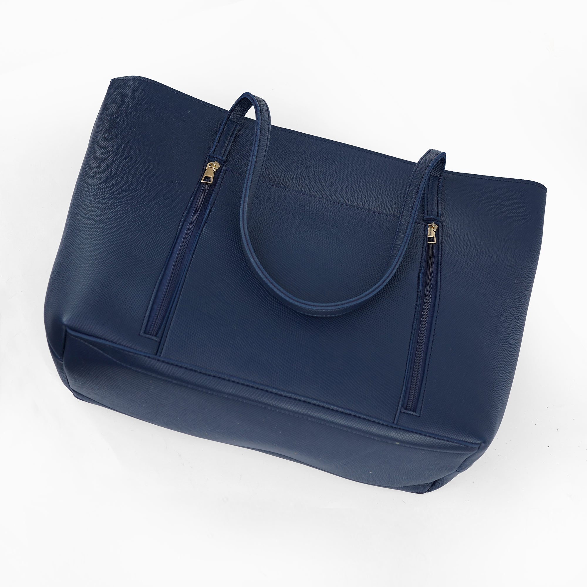 Angled view of the Zara navy blue shoulder bag, highlighting the front pockets and textured material