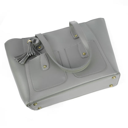Angled view of the Alizeh grey tote bag, highlighting the chic tassel detail and structured design