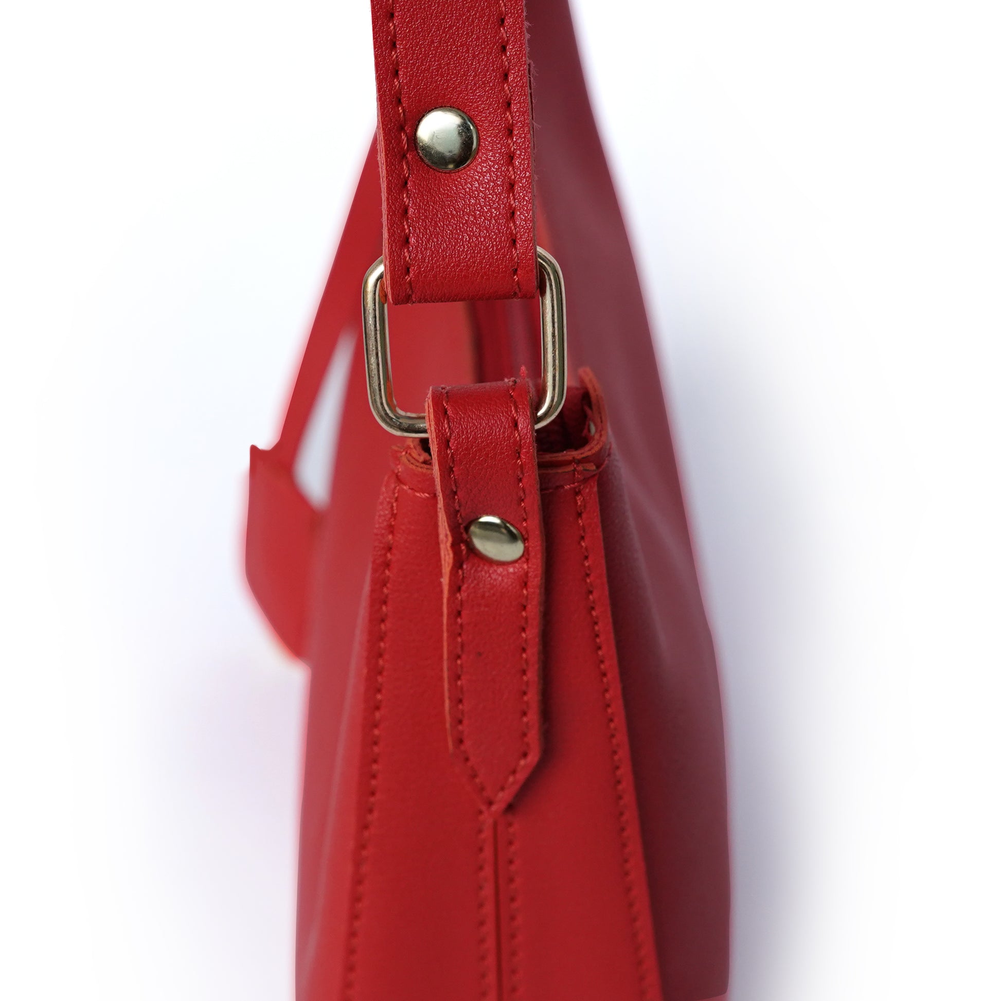Close-up view of red shoulder bag with fitting