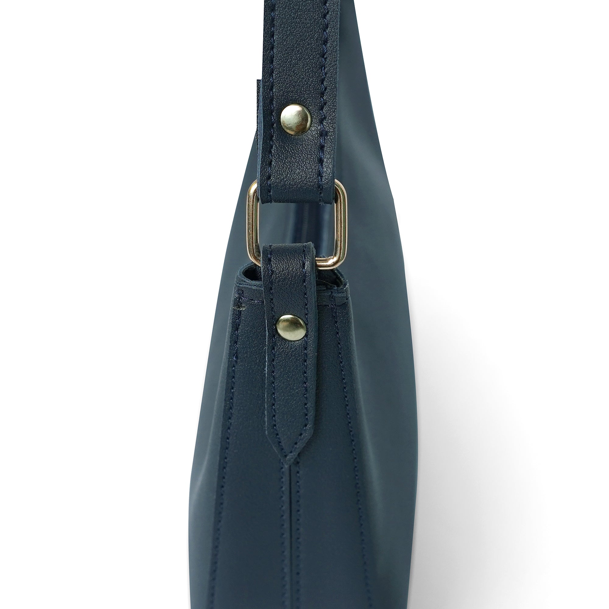Detailed view of blue shoulder bag with gold hardware