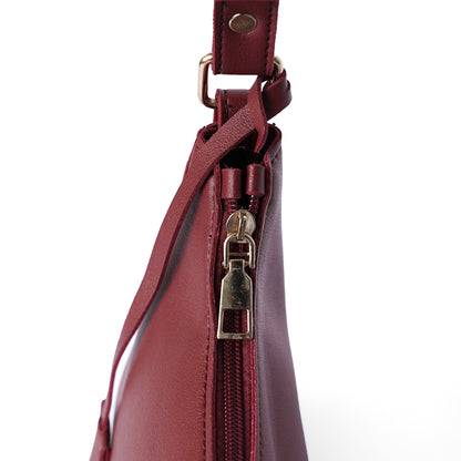 Maroon shoulder bag with handle design and zip closure