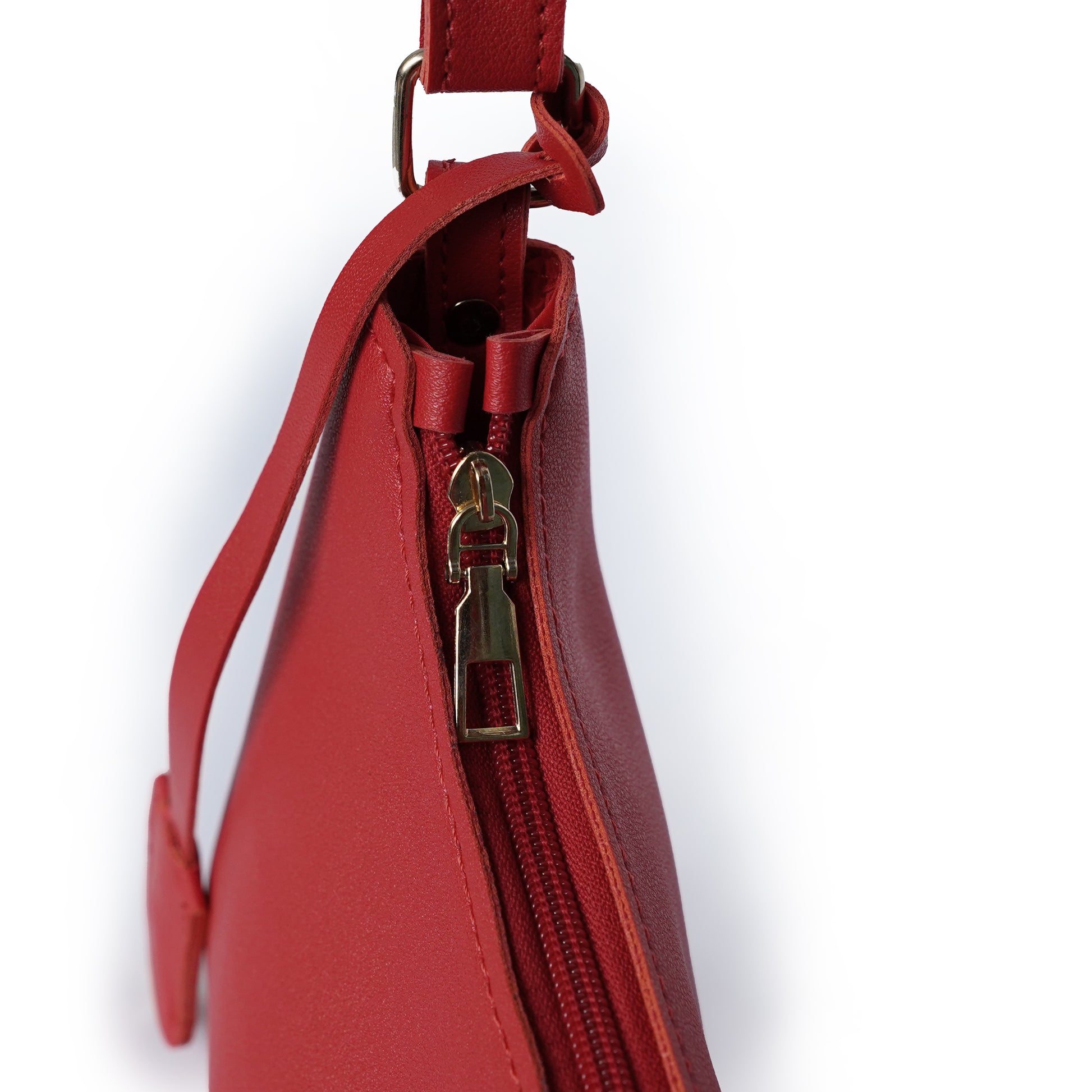 Zipper detail of red faux leather shoulder bag