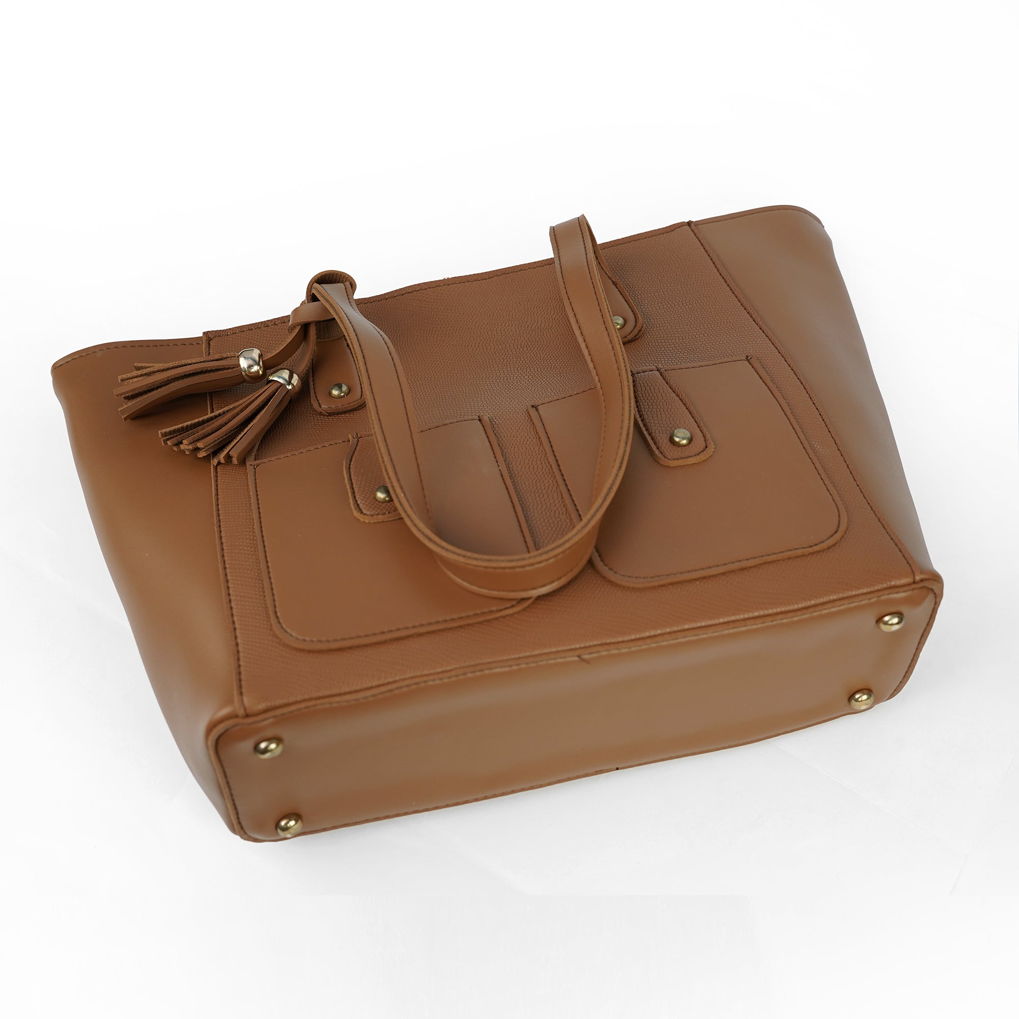 Angled view of the Alizeh brown tote bag, highlighting the front flap pockets, tassel, and structured base