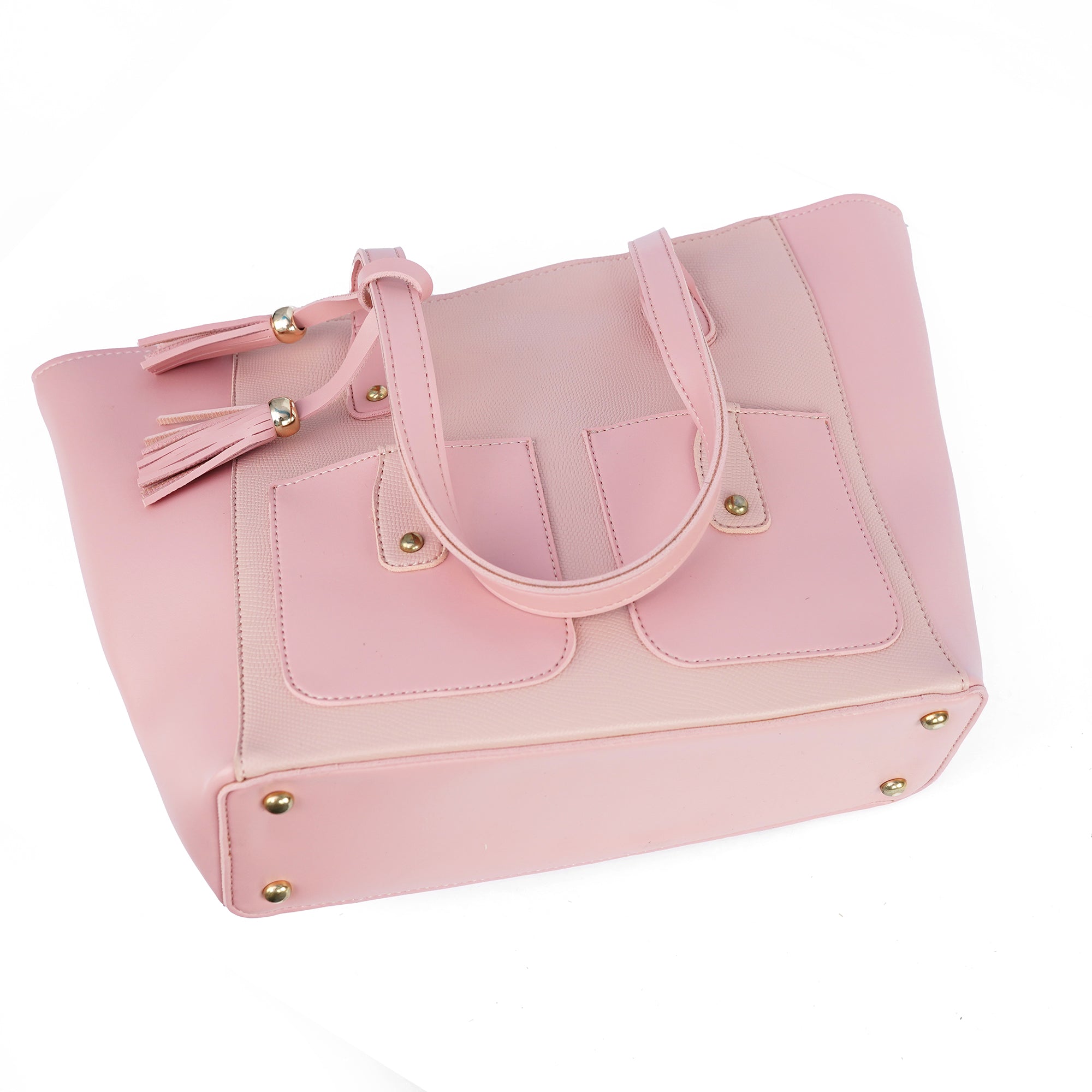 Angled view of the Alizeh pink tote bag, highlighting the front flap pockets and the playful tassel