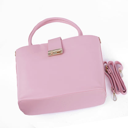 Side angle view of the Serena pastel pink handbag showing its elegant form.
